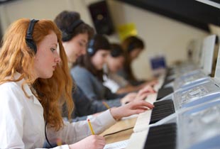 Pupils Working at Keyboards During a Class Music Lesson at Kimbolton School